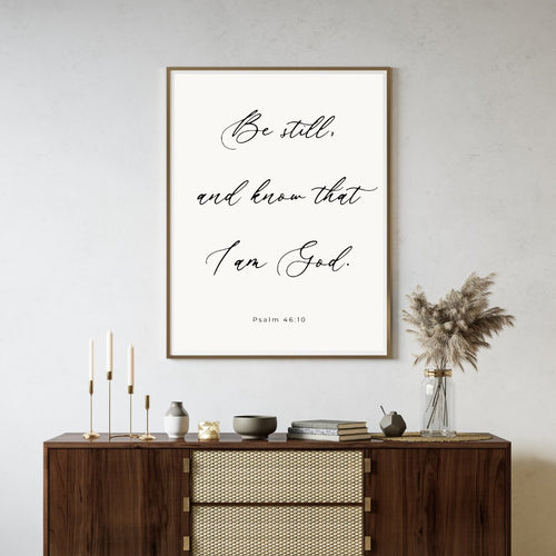 'Be Still, and know that I am God' psalm 46:10 text wall art piece hanging on a living room wall