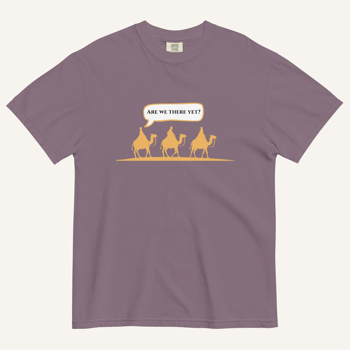 a wine purple t-shirt with 3 men riding camels in the color yellow with a chat bubble with the text "are we there yet?"