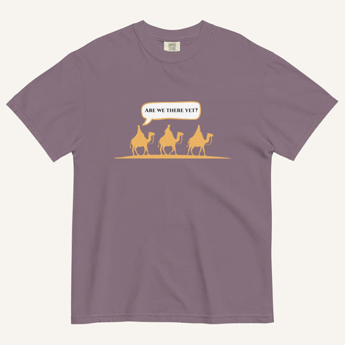 a wine purple t-shirt with 3 men riding camels in the color yellow with a chat bubble with the text "are we there yet?"