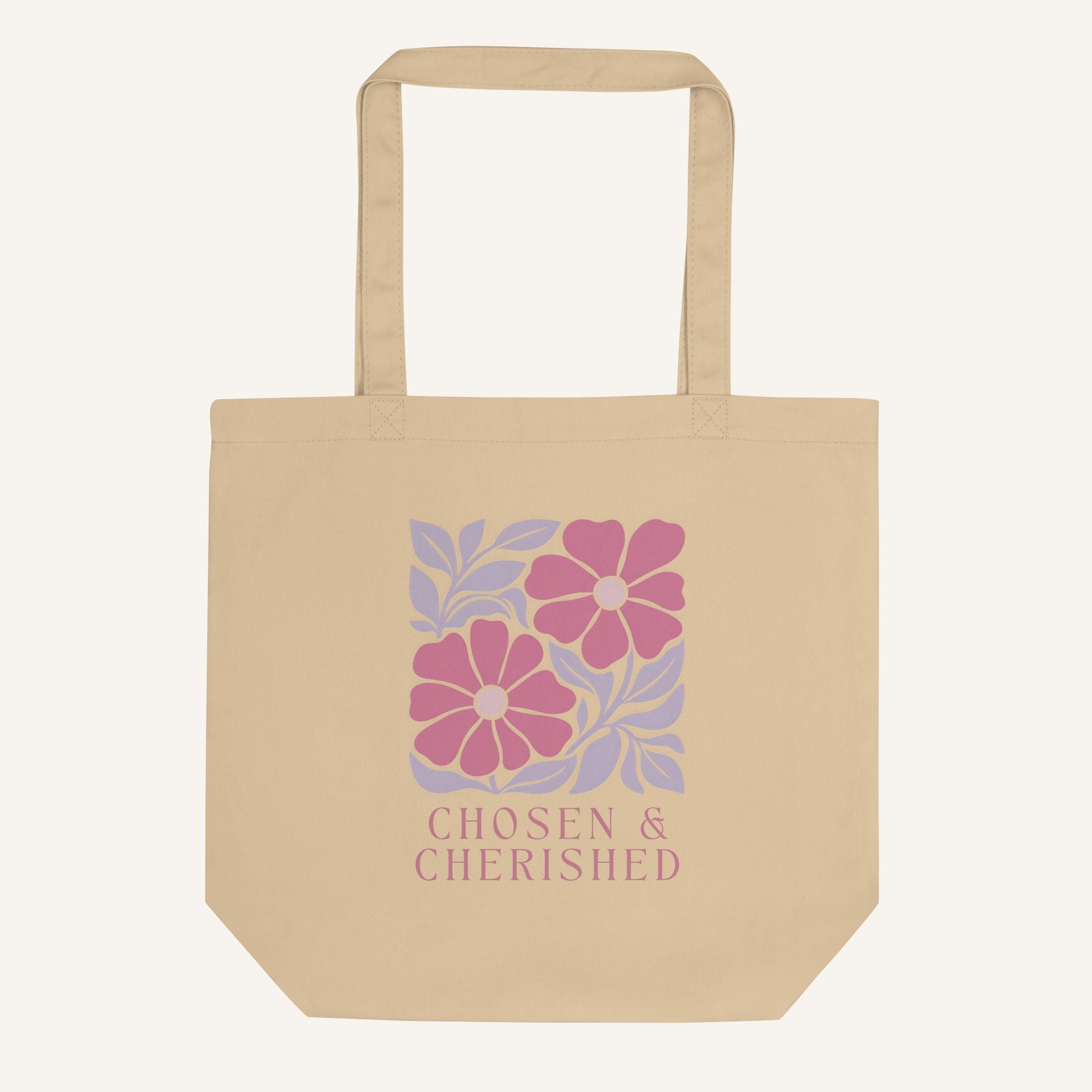 Beige tote bag with floral design and 'Chosen & Cherished' text on a cream background