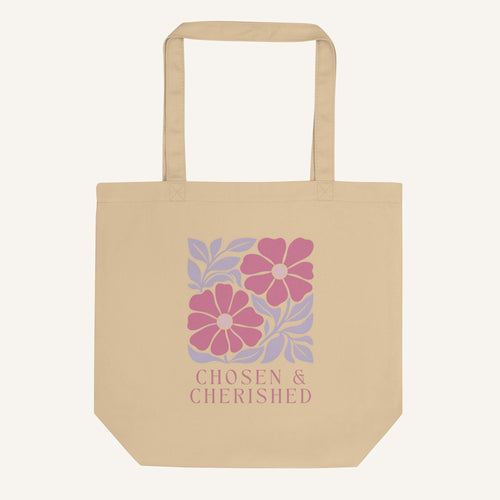 Beige tote bag with floral design and 'Chosen & Cherished' text on a cream background