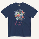 A navy blue short-sleeve t-shirt with a watercolor-style graphic of various berries (strawberries, blueberries, blackberries) and the text 'Berry Blessed' printed below it in pink, displayed on a light cream background.