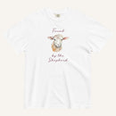 white t-shirt with watercolor lamb and 'Found by the Shepherd' text on cream background