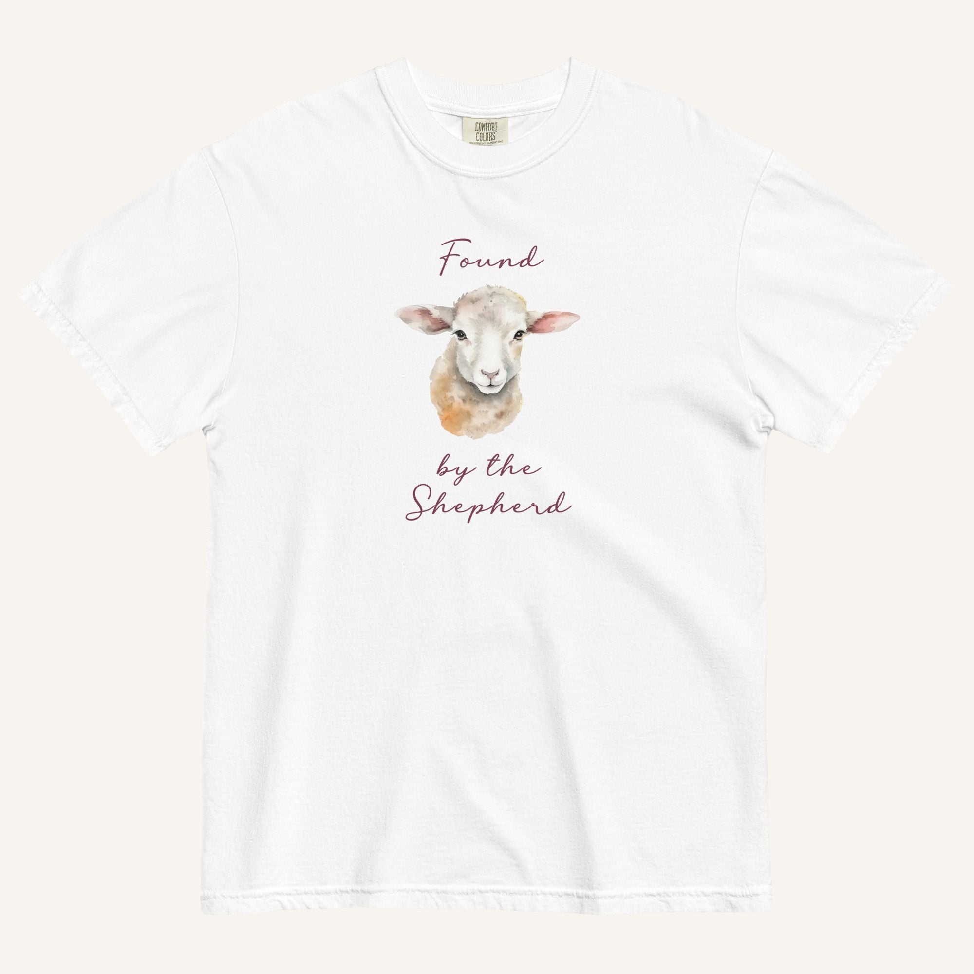 white t-shirt with watercolor lamb and 'Found by the Shepherd' text on cream background