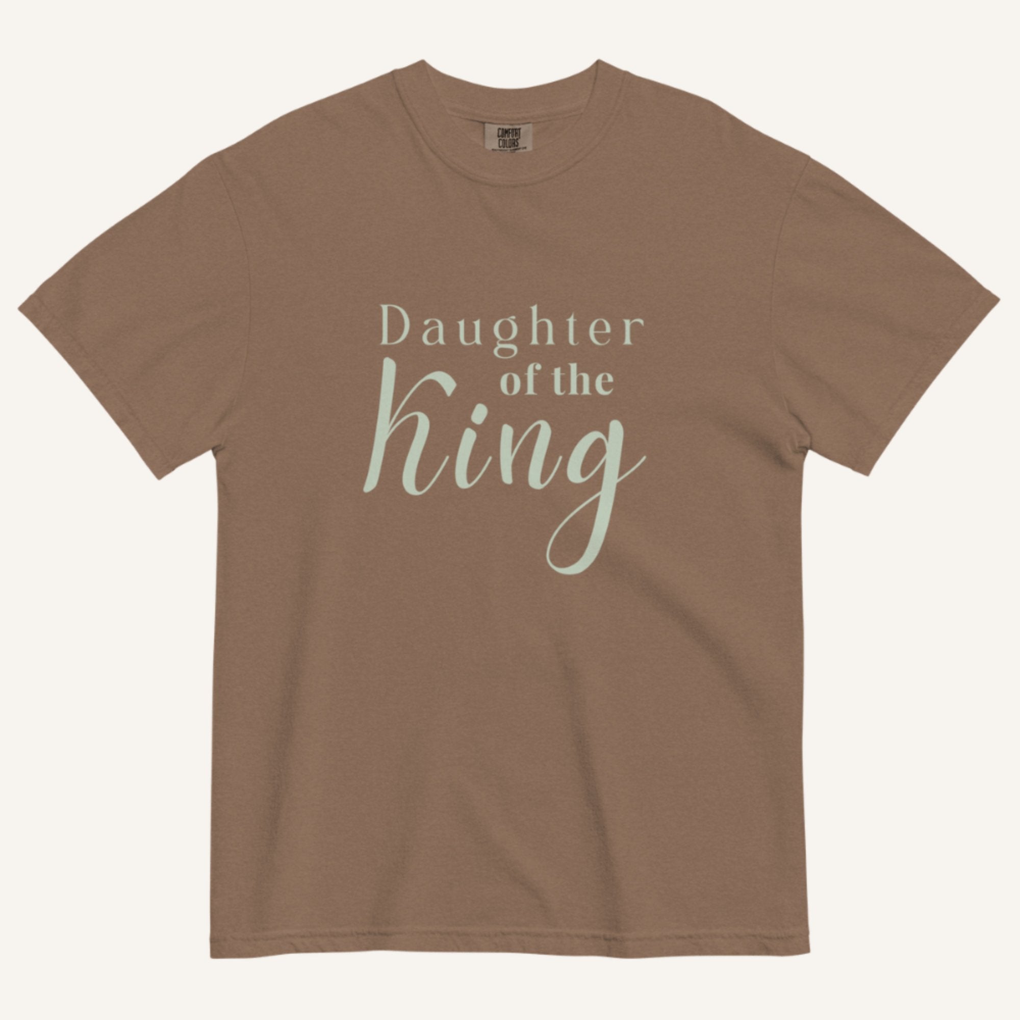 Brown t-shirt with 'Daughter of the King' text on a white background