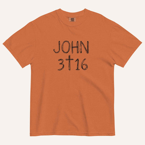 An orange short-sleeve crewneck t-shirt with 'JOHN 3 16' text with cross graphic in between the 3 & 16 printed in a black hand-drawn font on the chest, displayed flat against a light cream background.