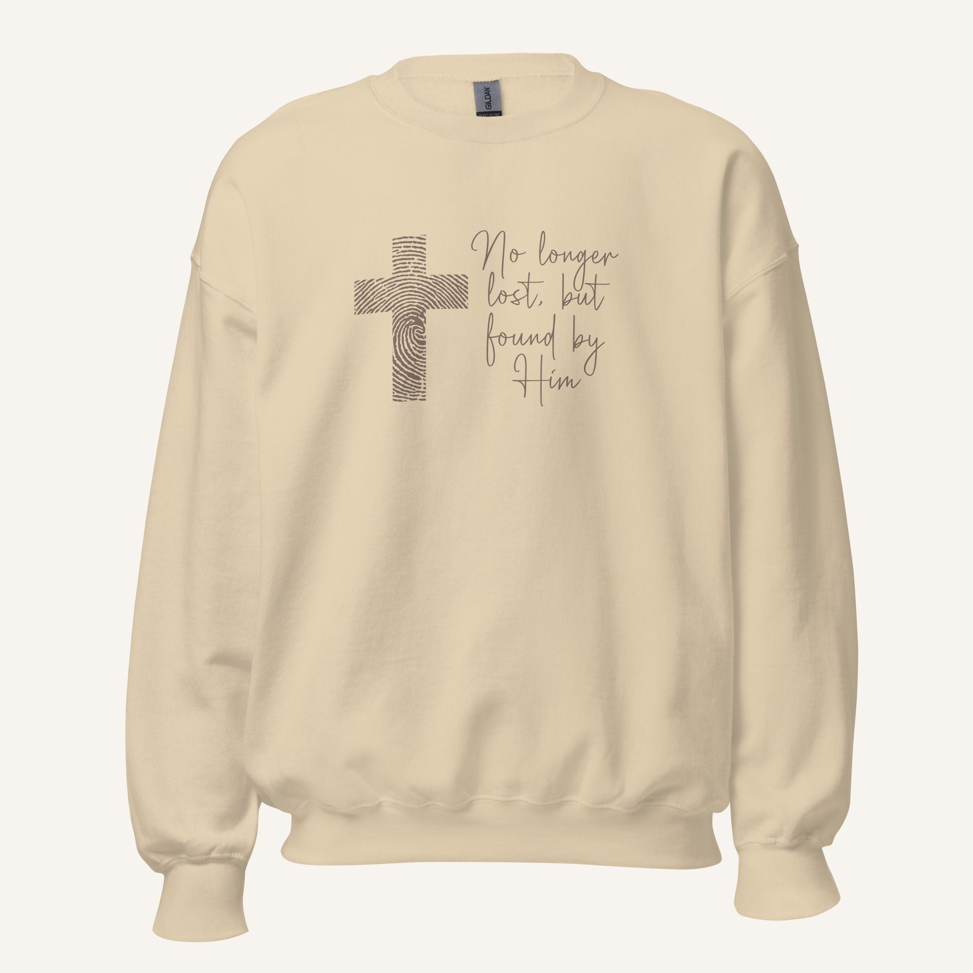 cream sweatshirt with cross design and 'No longer lost, but found by Him' text on a cream background