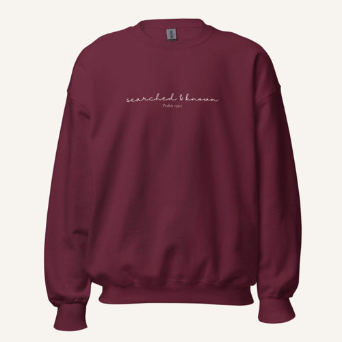 maroon sweatshirt with 'Searched & known' text