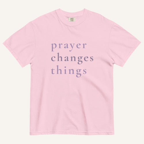 Pink t-shirt with 'prayer changes things' text on a white background