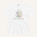 White t-shirt with floral design and 'Matthew 6:28' text on a white background