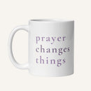 White 11 oz mug with 'prayer changes things' text in purple on a white background