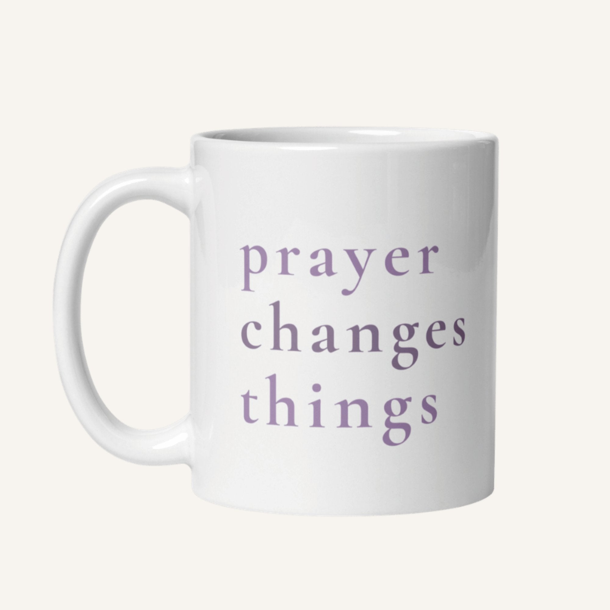 White 11 oz mug with 'prayer changes things' text in purple on a white background