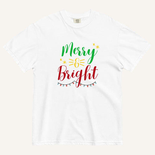 a white t-shirt that has "Merry & Bright" colored text with Christmas lights and star graphics