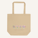Beige tote bag with floral design and 'Faith & Wildflowers' text on a white background