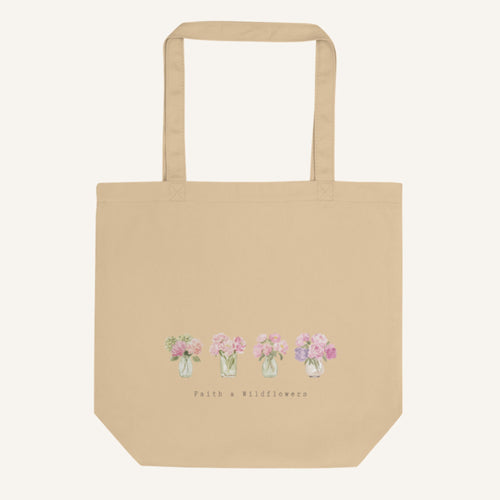 Beige tote bag with floral design and 'Faith & Wildflowers' text on a white background