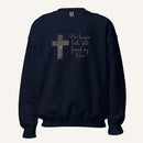 Navy blue sweatshirt with cross design and 'No longer lost, but found by Him' text on a cream background