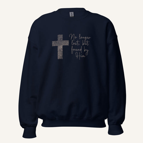 Navy blue sweatshirt with cross design and 'No longer lost, but found by Him' text on a cream background