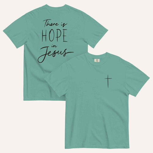 A seafoam green t-shirt shown from both the front and back. The front features a small black cross on the top left. The back features the black text 'There is HOPE in Jesus' in a mix of script and block lettering.