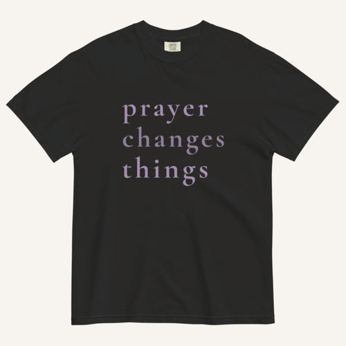Black t-shirt with 'prayer changes things' text on a white background