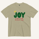a khaki color t-shirt with the words "Joy to the world, the Savior reigns" in bold colorful font with a star graphic