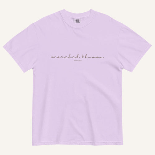 Lavender t-shirt with 'Searched & Known' text on a cream background