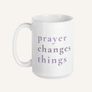 White 15 oz mug with 'prayer changes things' text in purple on a white background