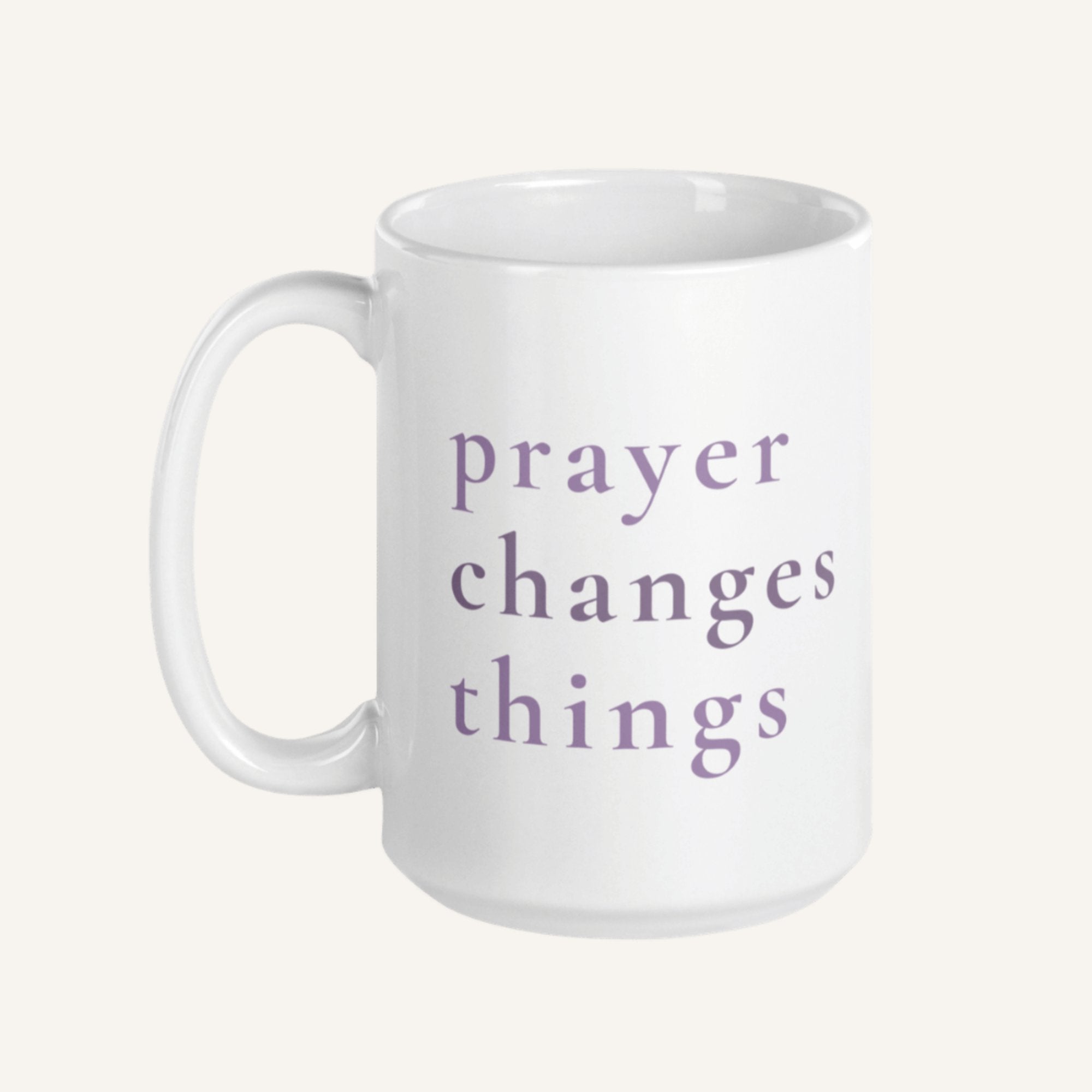 White 15 oz mug with 'prayer changes things' text in purple on a white background