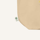Beige fabric with a green certification logo on a white background