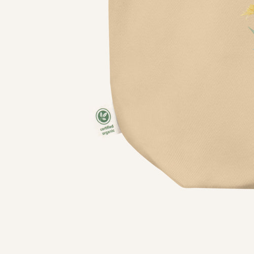 Beige fabric with a green certification logo on a white background