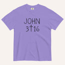 A lavender purple short-sleeve crewneck t-shirt with 'JOHN 3 16' text with cross graphic in between the 3 & 16 printed in a black hand-drawn font on the chest, displayed flat against a light cream background.