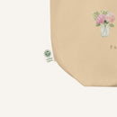 Beige product with floral design and certification logo on a white background