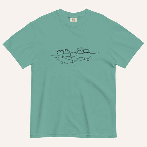 A teal blue short-sleeve crewneck t-shirt with a black graphic of two fish and 5 loaves of bread on a line and the cursive text 'Everyone Ate' across the chest, displayed flat against a light beige background.