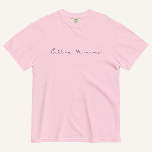 Pink t-shirt with 'Call on his name' text on a white background