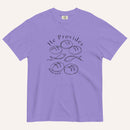 A purple short-sleeve t-shirt with a black graphic print on the front showing fish and loaves of bread, with the text 'He Provides' and 'Matthew 14:13-21'.
