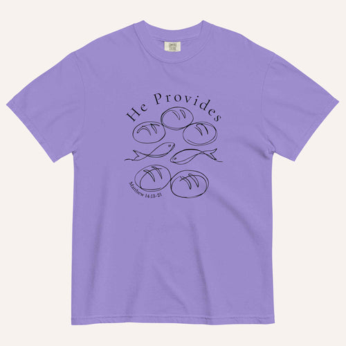 A purple short-sleeve t-shirt with a black graphic print on the front showing fish and loaves of bread, with the text 'He Provides' and 'Matthew 14:13-21'.