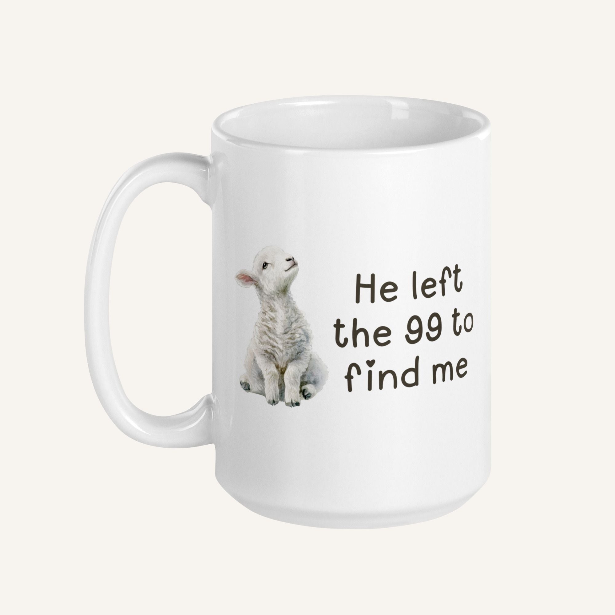 white 15 oz mug with a water color lamb and 'He left the 99 to find me' text on a cream background