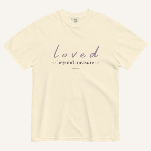 Beige t-shirt with 'loved beyond measure' text on a white background