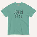 A teal short-sleeve crewneck t-shirt with 'JOHN 3 16' text with cross graphic in between the 3 & 16 printed in a black hand-drawn font on the chest, displayed flat against a light cream background.
