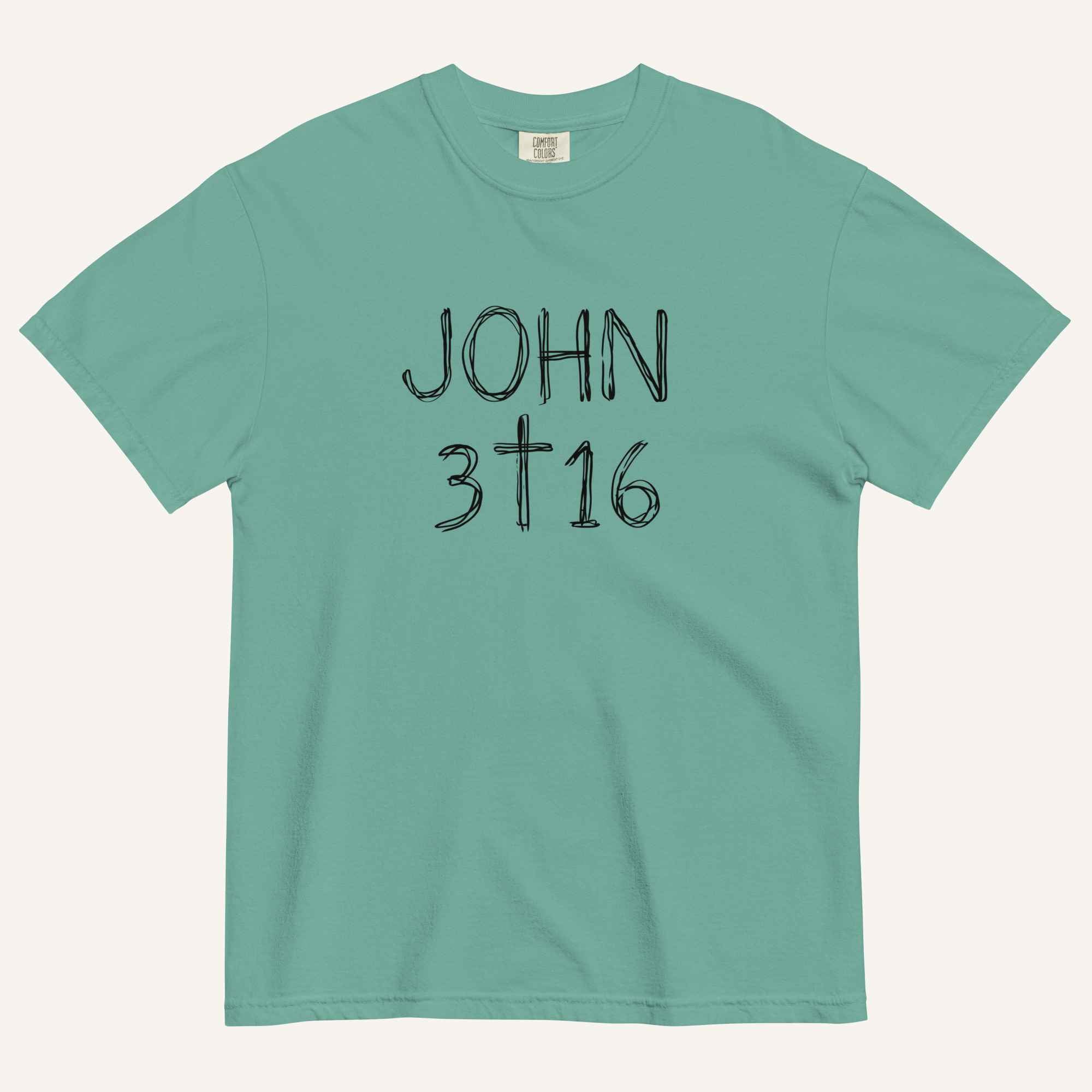 A teal short-sleeve crewneck t-shirt with 'JOHN 3 16' text with cross graphic in between the 3 & 16 printed in a black hand-drawn font on the chest, displayed flat against a light cream background.