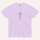 A short-sleeve crewneck t-shirt in a light lavender color, featuring a simple black Christian cross printed on the center chest. The t-shirt is laid flat against a solid, warm off-white background.