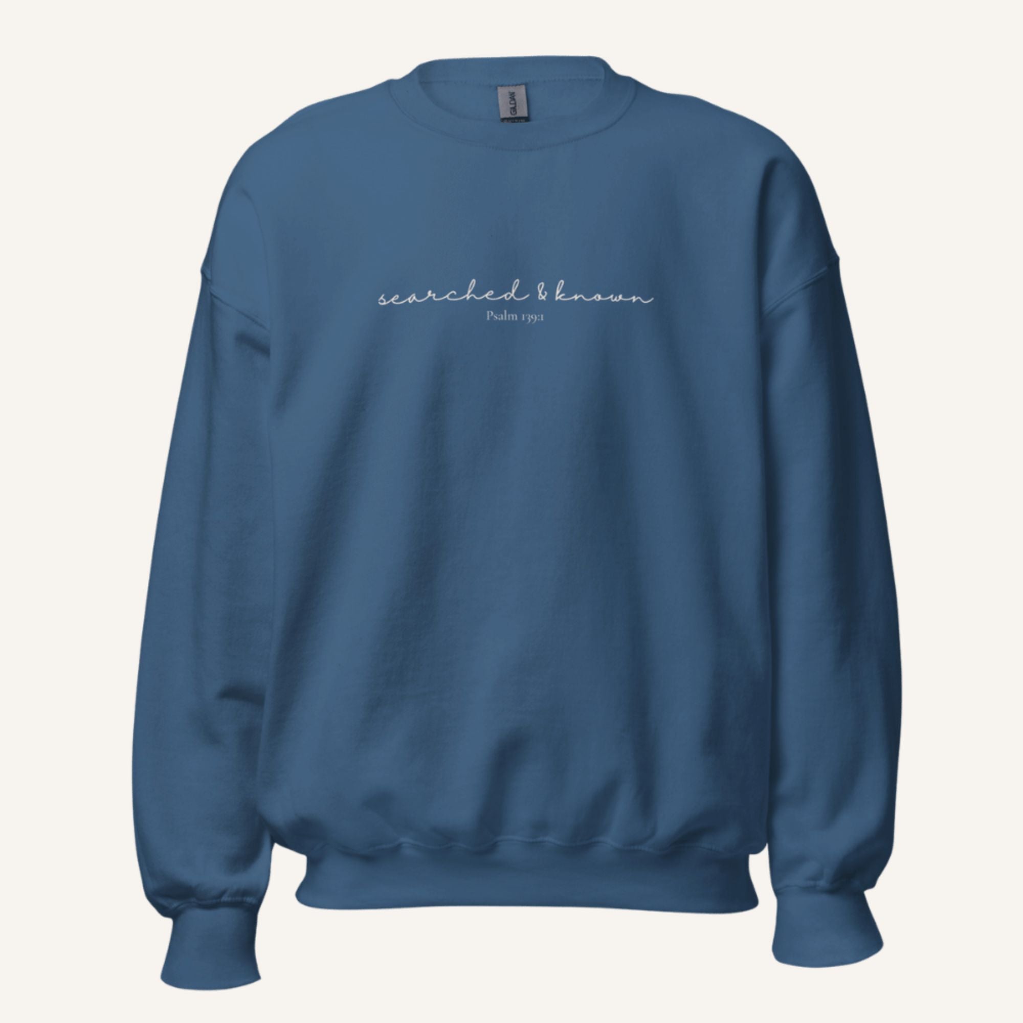 blue sweatshirt with 'Searched & known' text