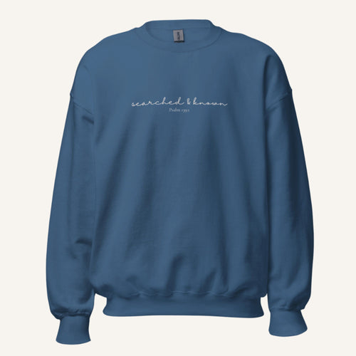 blue sweatshirt with 'Searched & known' text