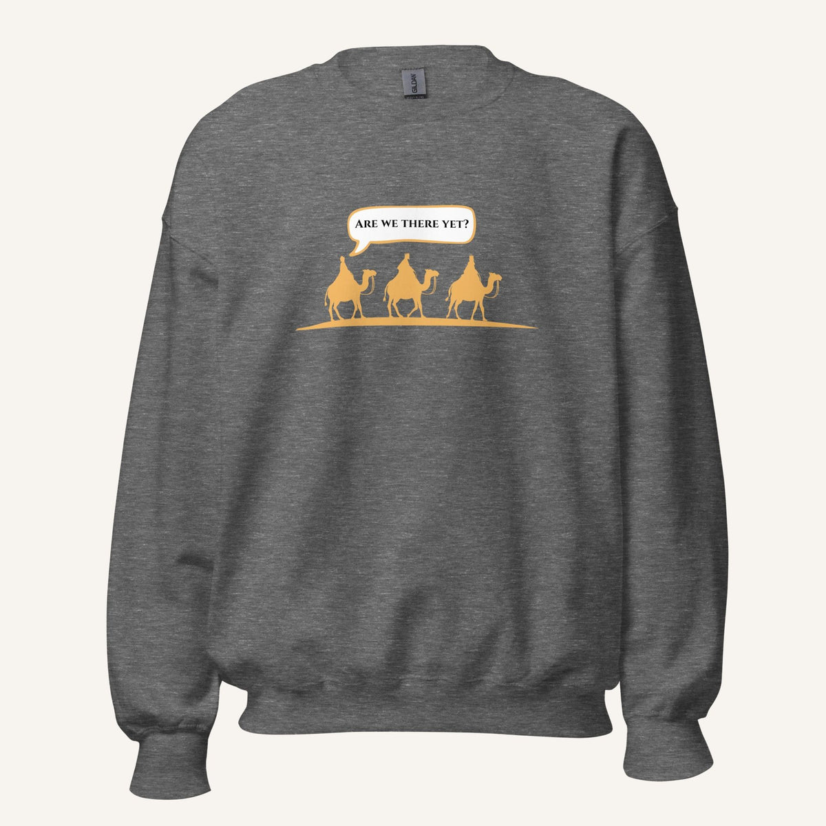 Grey heather unisex crewneck sweatshirt featuring a gold desert scene with three camels and a speech bubble reading “Are we there yet?”