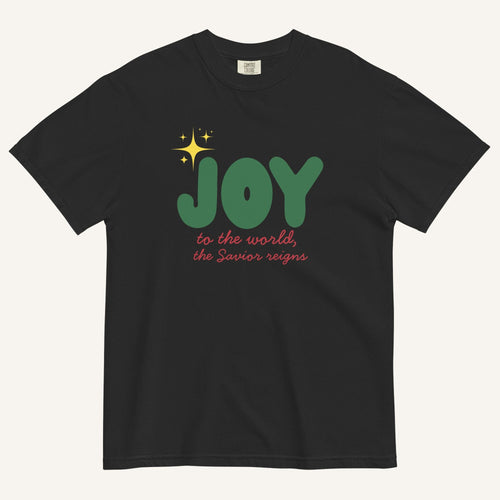 a black t-shirt with the words "Joy to the world, the Savior reigns" in bold colorful font with a star graphic
