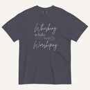 navy t-shirt with "Whisking while worshiping" text and a whisk graphic