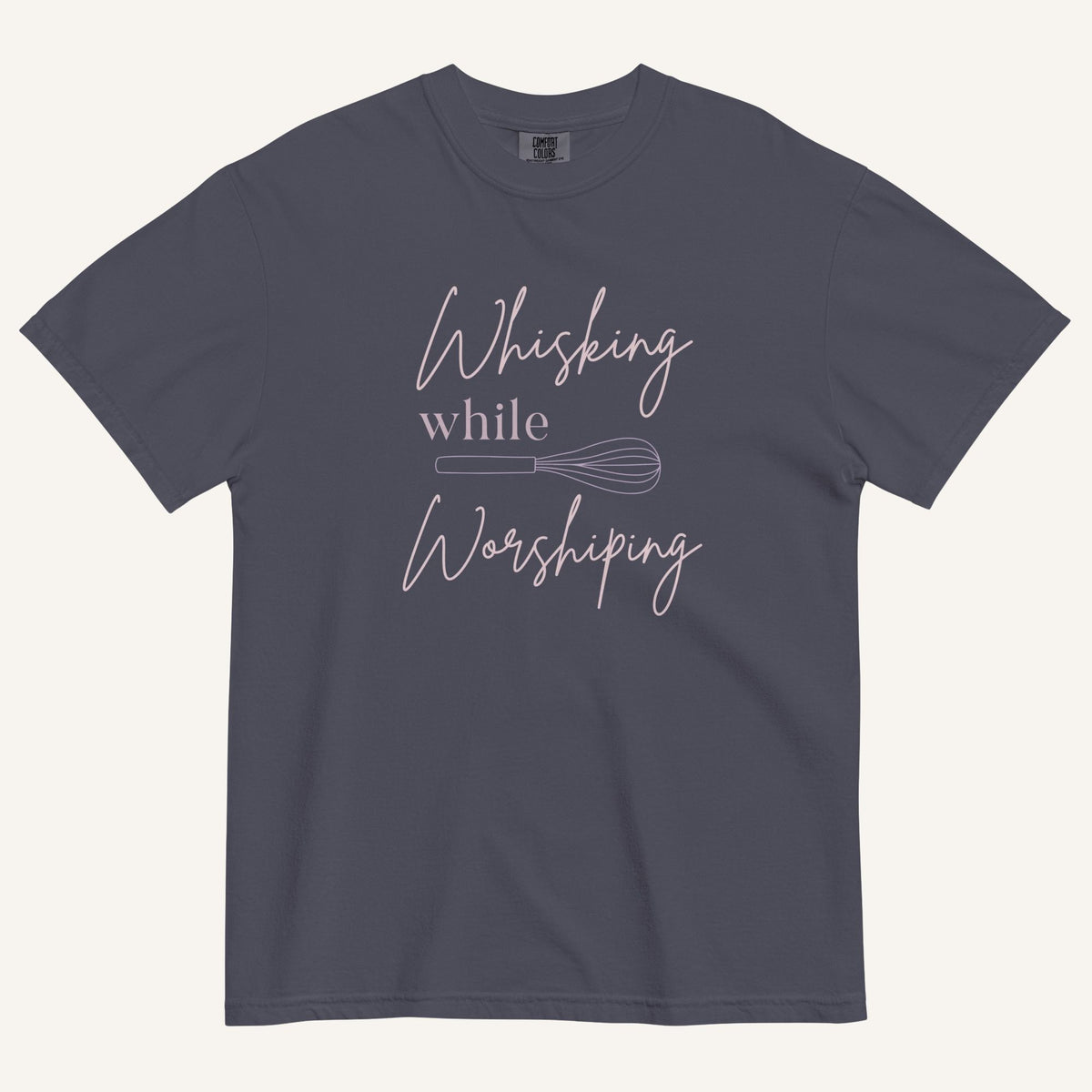navy t-shirt with "Whisking while worshiping" text and a whisk graphic
