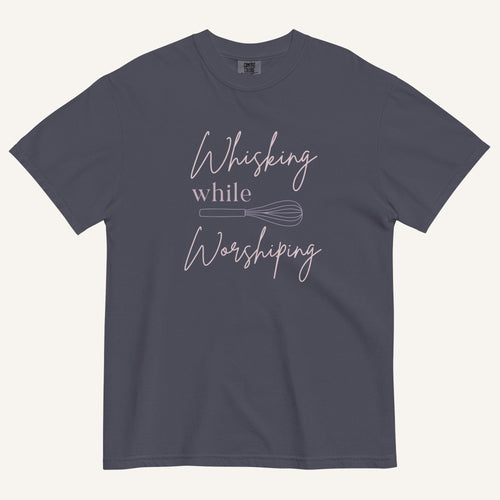 navy t-shirt with "Whisking while worshiping" text and a whisk graphic