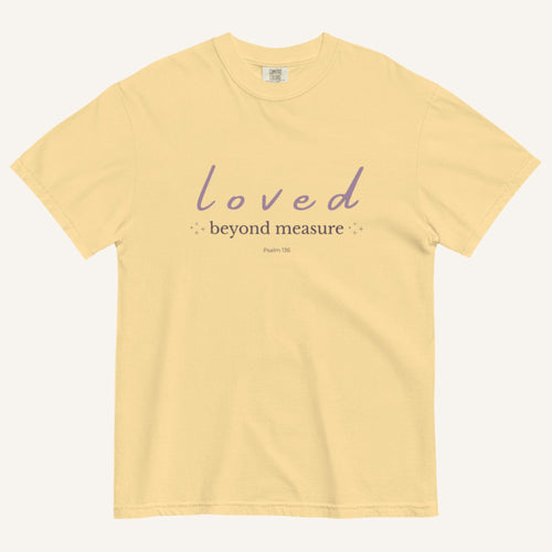 Yellow t-shirt with 'loved beyond measure' text on a white background
