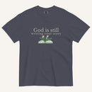 blue grey t-shirt with 'God is still writing your story' text and book graphic on a white background