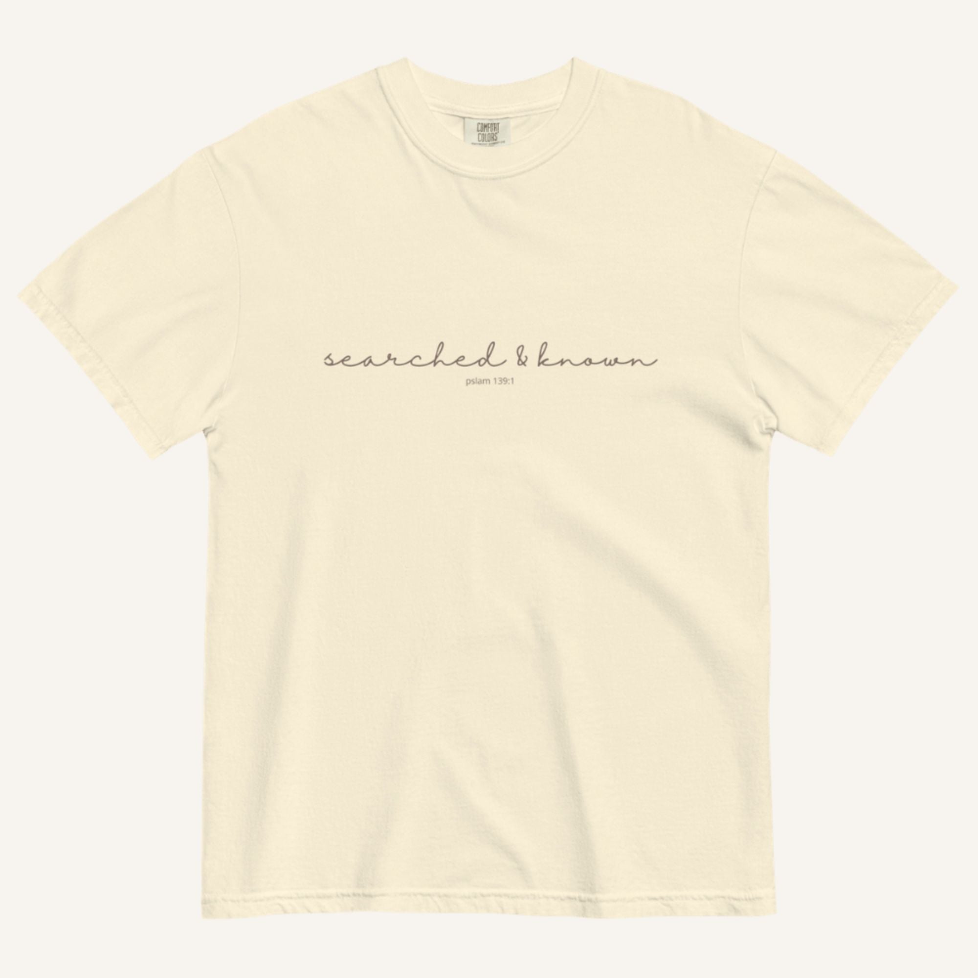 Ivory t-shirt with 'Searched & Known' text on a cream background